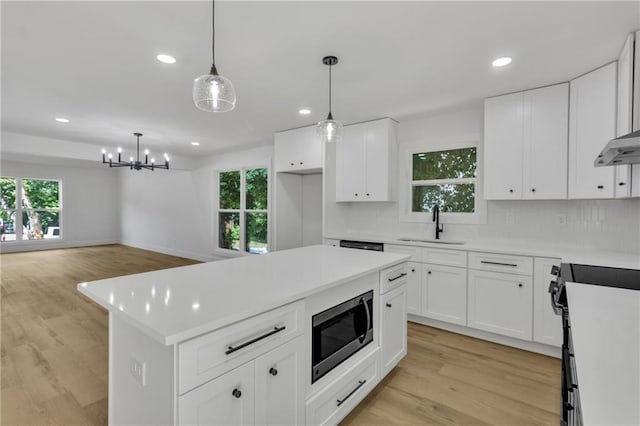 2601 Garland Way, Duluth, GA 30096 - kitchen with stainless steel microwave, a sink, electric stove, recessed lighting, and light wood-type flooring
