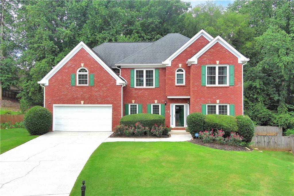 view of front of home featuring a garage and a front lawn