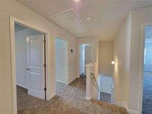115 Deer Xing, Temple, GA 30179 - hall featuring attic access, baseboards, and an upstairs landing