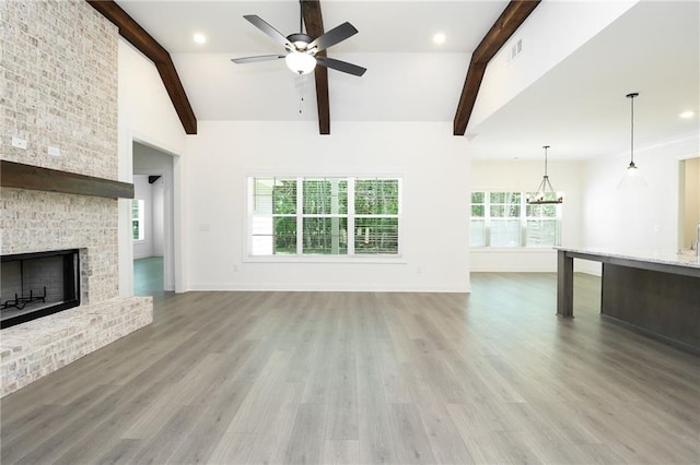 2109 Ella Springs Dr, Covington, GA 30014 - unfurnished living room with ceiling fan, light wood-style floors, a chandelier, a brick fireplace, and baseboards