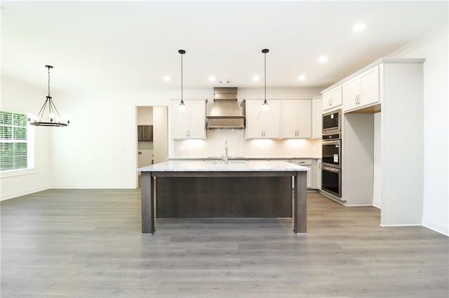 2109 Ella Springs Dr, Covington, GA 30014 - kitchen featuring custom exhaust hood, a chandelier, baseboards, white cabinets, and light wood-style flooring