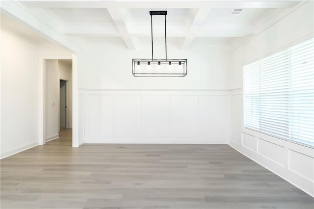 2109 Ella Springs Dr, Covington, GA 30014 - unfurnished dining area with a decorative wall, beamed ceiling, coffered ceiling, light wood-style floors, and a chandelier