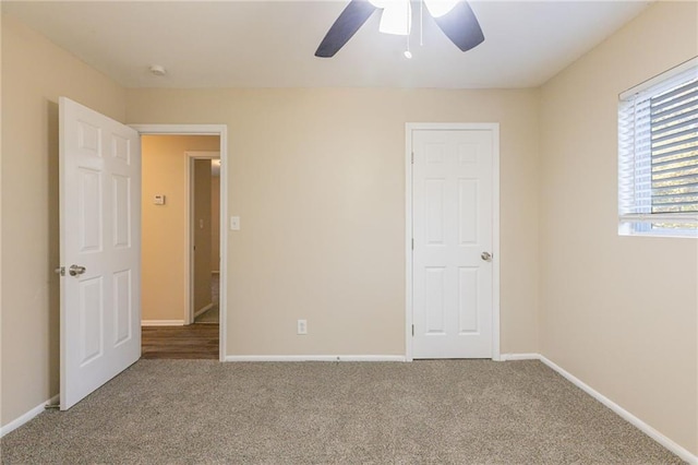 unfurnished bedroom with ceiling fan and carpet flooring