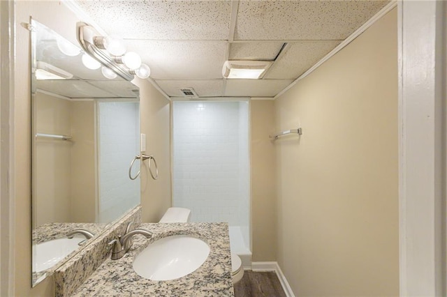 bathroom with toilet, ornamental molding, hardwood / wood-style floors, vanity, and walk in shower