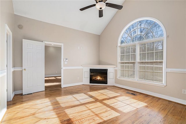 unfurnished living room with lofted ceiling, ceiling fan, and hardwood / wood-style flooring