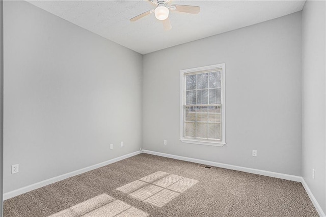 carpeted empty room featuring ceiling fan