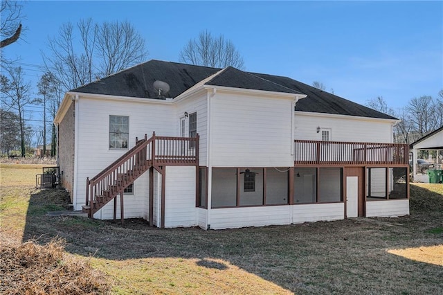 back of house with a yard and a sunroom