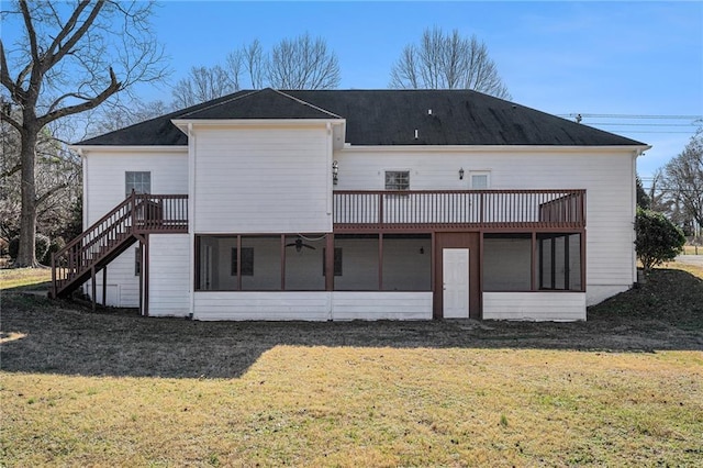 rear view of house with a yard and a sunroom