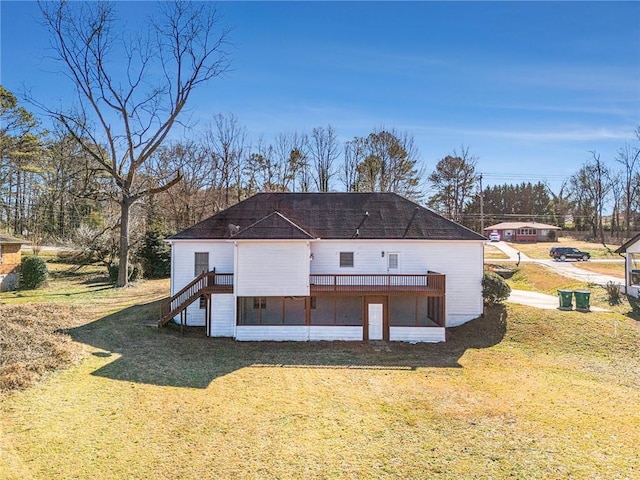 rear view of property featuring a lawn