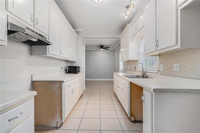 kitchen featuring white cabinets, ceiling fan, sink, and light tile patterned floors