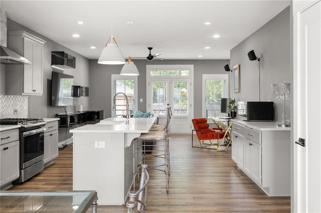 3484 Orchard St, Atlanta, GA 30354 - kitchen featuring stainless steel range with gas cooktop, wood finished floors, a ceiling fan, recessed lighting, and tasteful backsplash