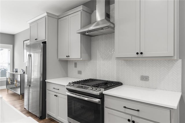 3484 Orchard St, Atlanta, GA 30354 - kitchen with appliances with stainless steel finishes, wall chimney range hood, decorative backsplash, dark wood-style flooring, and light countertops