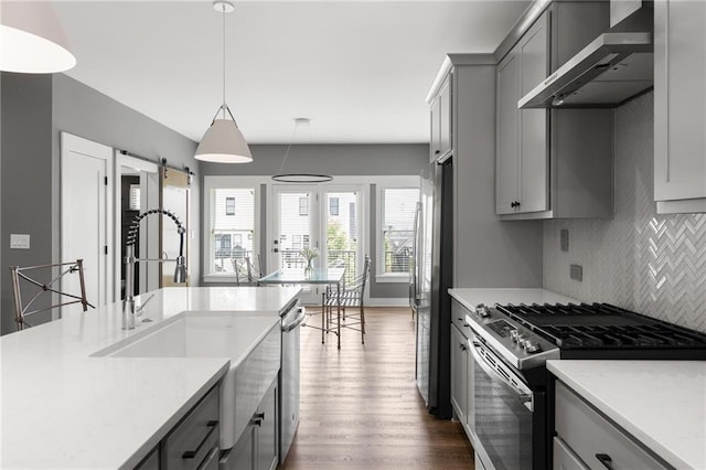 3484 Orchard St, Atlanta, GA 30354 - kitchen with appliances with stainless steel finishes, wall chimney exhaust hood, gray cabinets, backsplash, and light countertops