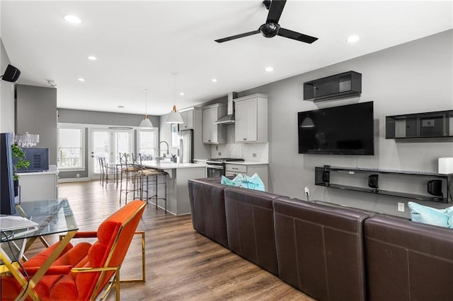3484 Orchard St, Atlanta, GA 30354 - kitchen featuring open floor plan, stainless steel appliances, wall chimney range hood, a kitchen bar, and light countertops