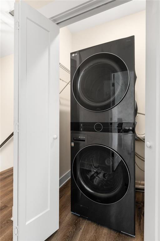 3484 Orchard St, Atlanta, GA 30354 - laundry room featuring stacked washing machine and dryer and wood finished floors