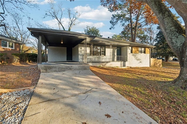 view of front of property with covered porch and a carport