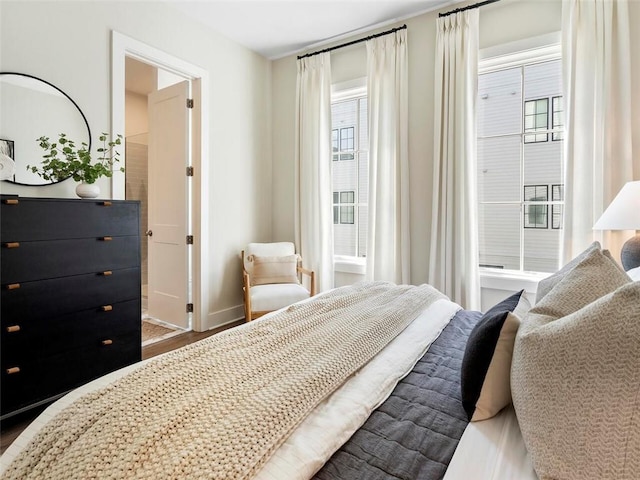 bedroom with baseboards and wood finished floors