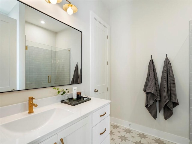 bathroom featuring baseboards, a shower stall, vanity, and tile patterned floors