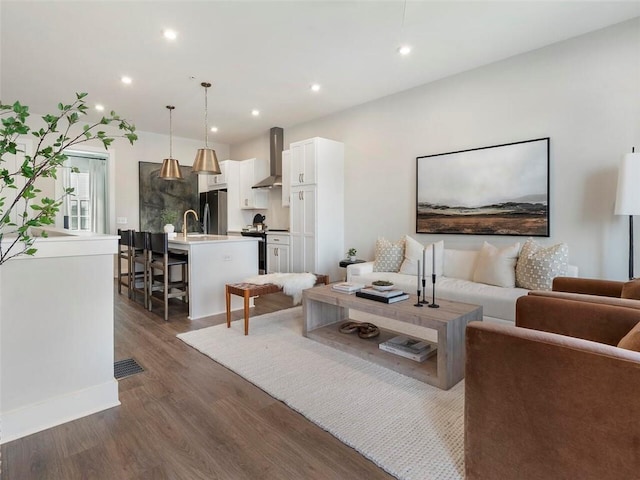 living area featuring visible vents, dark wood finished floors, and recessed lighting