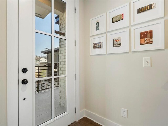 doorway featuring baseboards