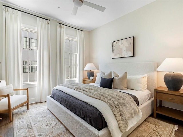 bedroom with light wood-type flooring and a ceiling fan