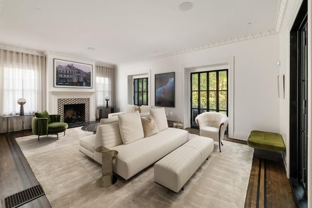 living room with light hardwood / wood-style floors and a tile fireplace