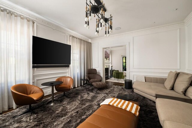 living room featuring a notable chandelier and ornamental molding