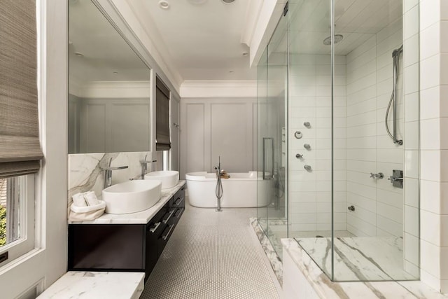 bathroom featuring tasteful backsplash, vanity, plus walk in shower, ornamental molding, and tile patterned floors