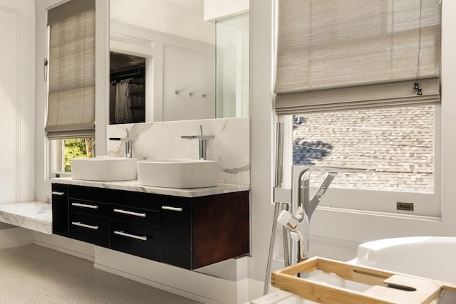 bathroom with vanity and tasteful backsplash