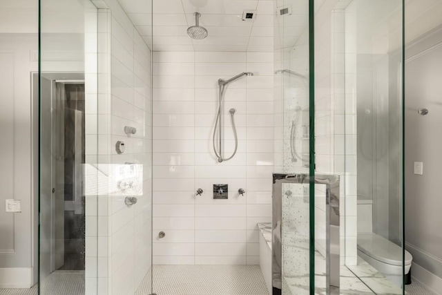 bathroom with toilet and a shower with shower door