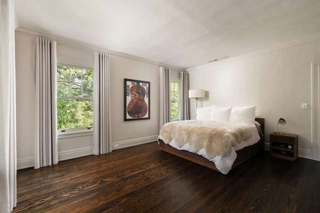 bedroom featuring crown molding and dark wood-type flooring