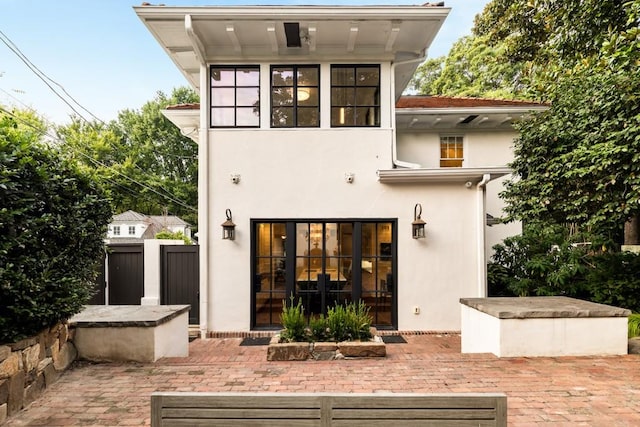 rear view of house with french doors and a patio area