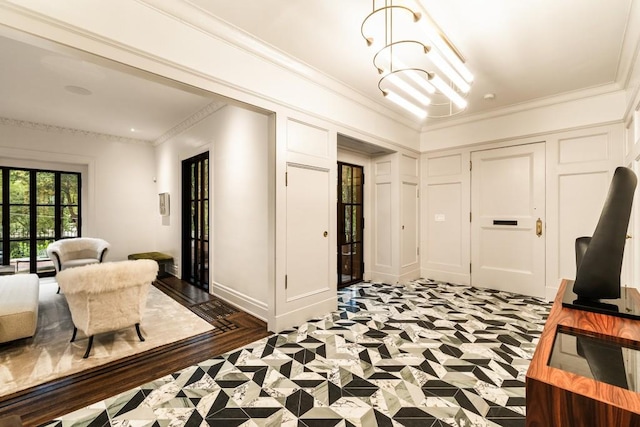 interior space with a notable chandelier, crown molding, and dark hardwood / wood-style flooring