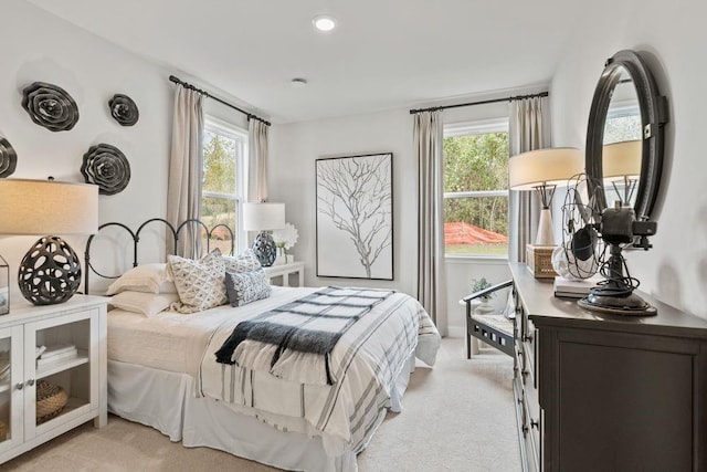 bedroom featuring light colored carpet