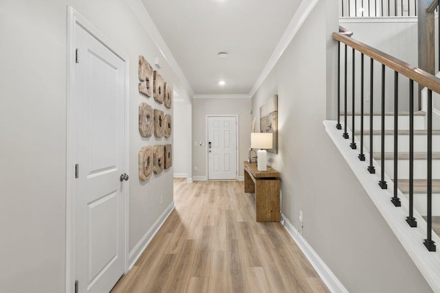 corridor featuring light hardwood / wood-style floors and crown molding