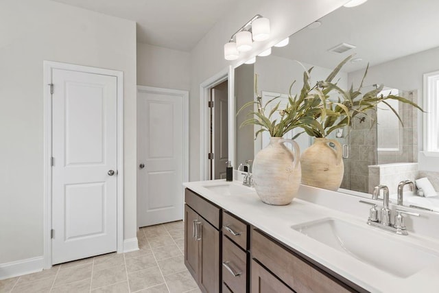 bathroom with tile patterned flooring, vanity, and an enclosed shower