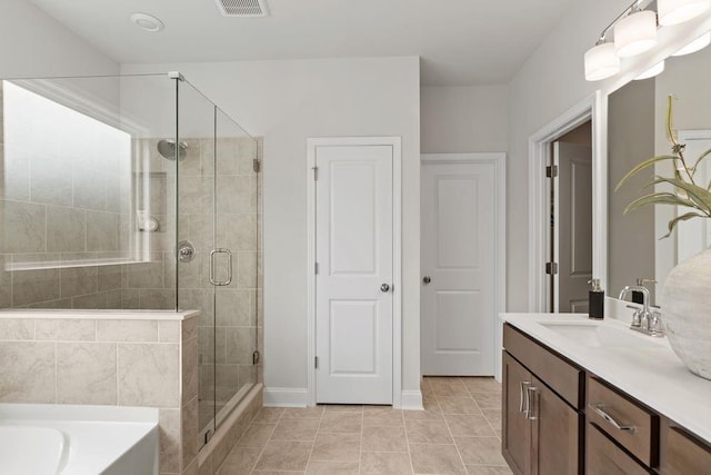 bathroom with tile patterned floors, vanity, and shower with separate bathtub