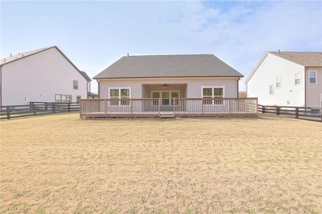 back of property featuring a yard and a wooden deck