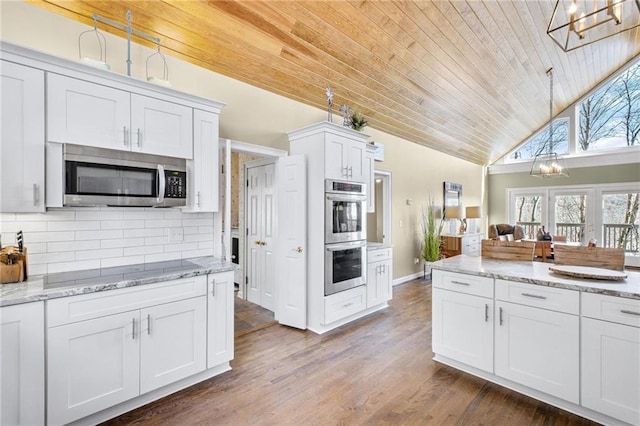 kitchen featuring appliances with stainless steel finishes, wood ceiling, a chandelier, and backsplash