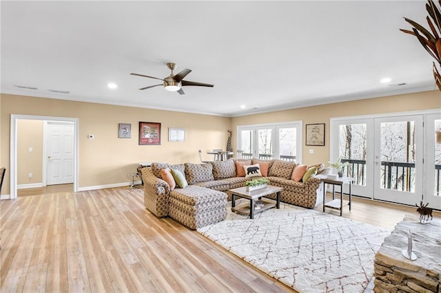 living room with light wood-style floors, recessed lighting, baseboards, and french doors