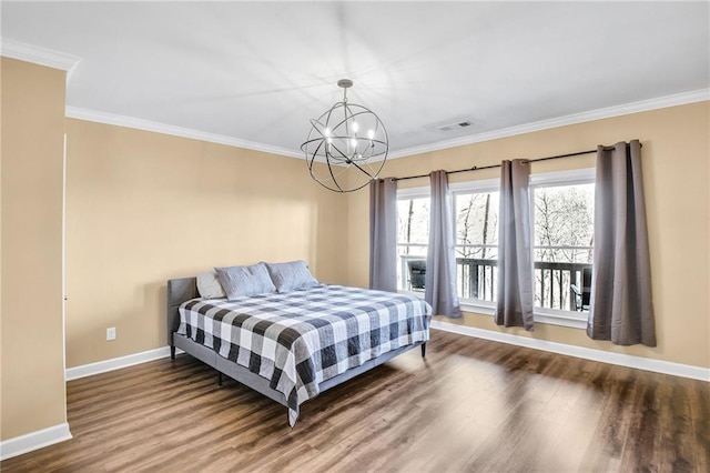 bedroom featuring crown molding, a chandelier, and wood finished floors