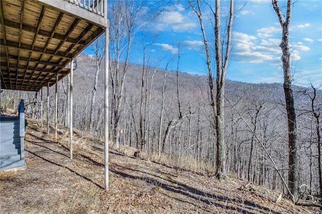 view of yard with a view of trees