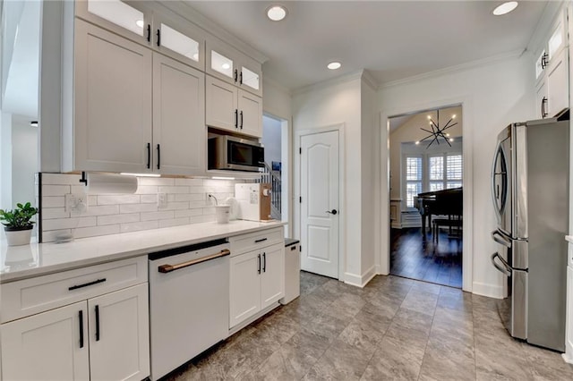 3355 Olivia Ct, Cumming, GA 30041 - kitchen featuring stainless steel appliances, a chandelier, backsplash, crown molding, and white cabinetry