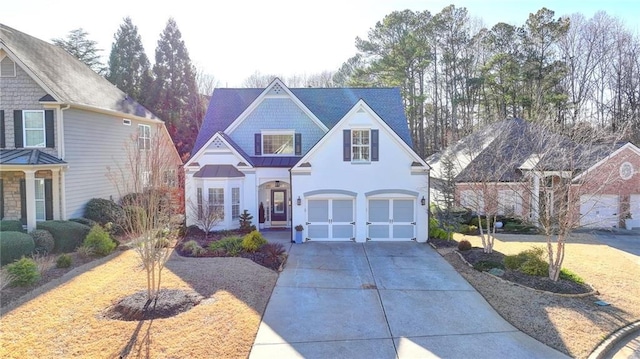 3355 Olivia Ct, Cumming, GA 30041 - traditional-style house featuring concrete driveway, an attached garage, a standing seam roof, stucco siding, and metal roof