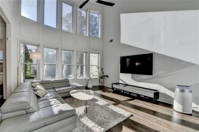 3355 Olivia Ct, Cumming, GA 30041 - living room with wood finished floors, ceiling fan, and a high ceiling