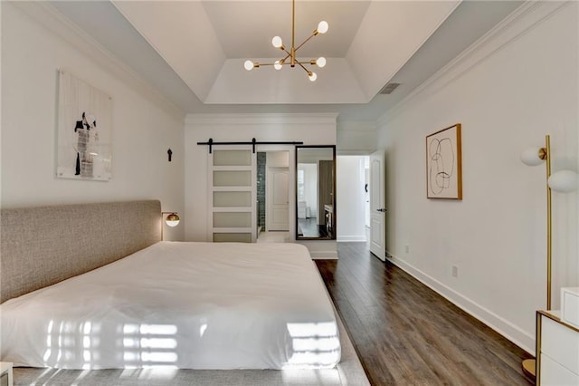 3355 Olivia Ct, Cumming, GA 30041 - bedroom featuring a tray ceiling, dark wood-style floors, a chandelier, a barn door, and ornamental molding