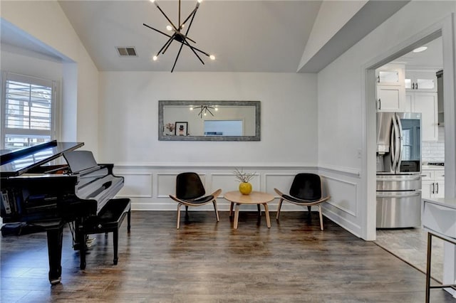 3355 Olivia Ct, Cumming, GA 30041 - sitting room with vaulted ceiling, a chandelier, wood finished floors, and a wainscoted wall