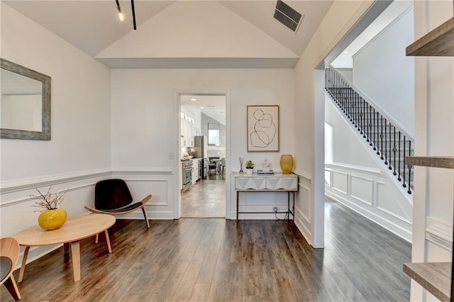 3355 Olivia Ct, Cumming, GA 30041 - sitting room with lofted ceiling, stairway, wood finished floors, a wainscoted wall, and a decorative wall