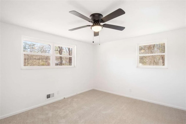 unfurnished room with ceiling fan and light carpet