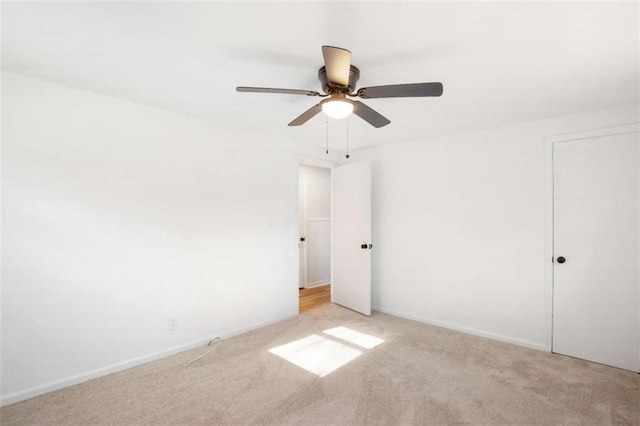 unfurnished bedroom featuring ceiling fan and light colored carpet